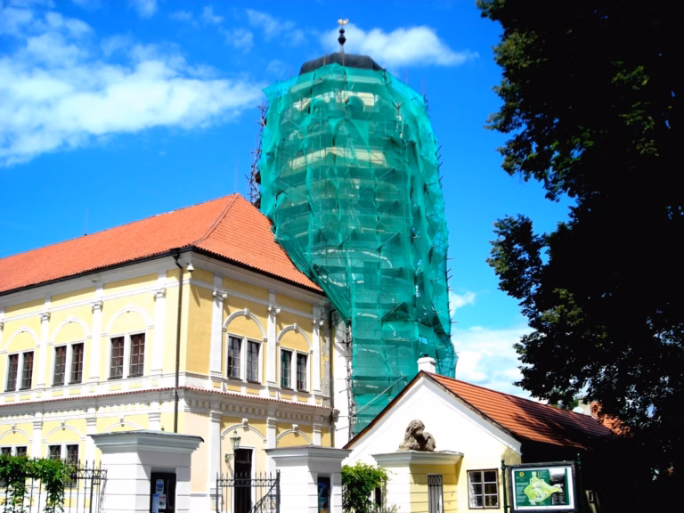 Lešení Benešov na kupoli věže se sítí u žluté budovy